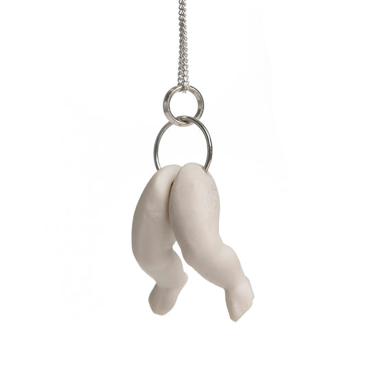 Hollow white porcelain doll's legs pendant produced by Martha Todd, one of the exhibiting artists of The Uncanny: A Centenary.