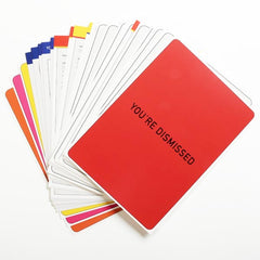 A pile of cards from the game Communicado, the top one reads "You're dismissed"